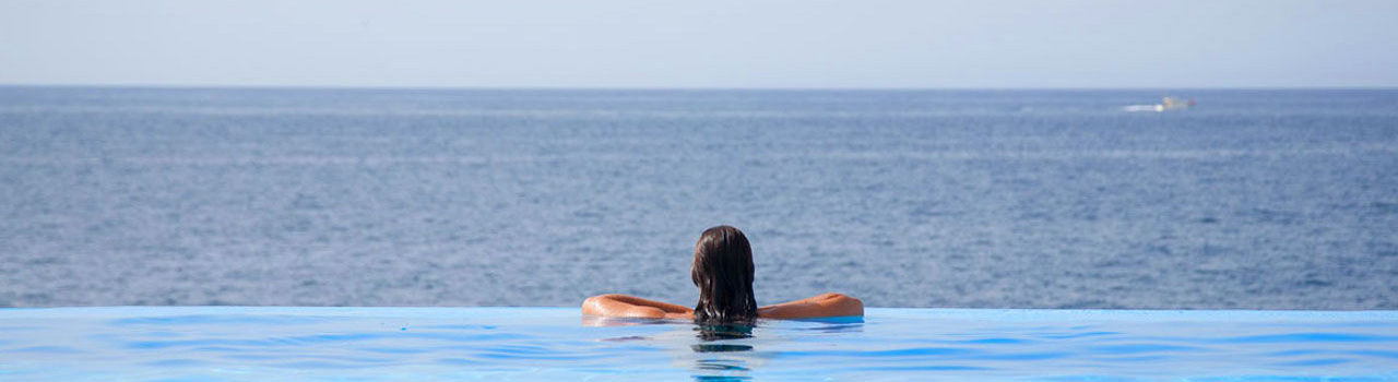 Girl at Vidamar pool looking to the sea